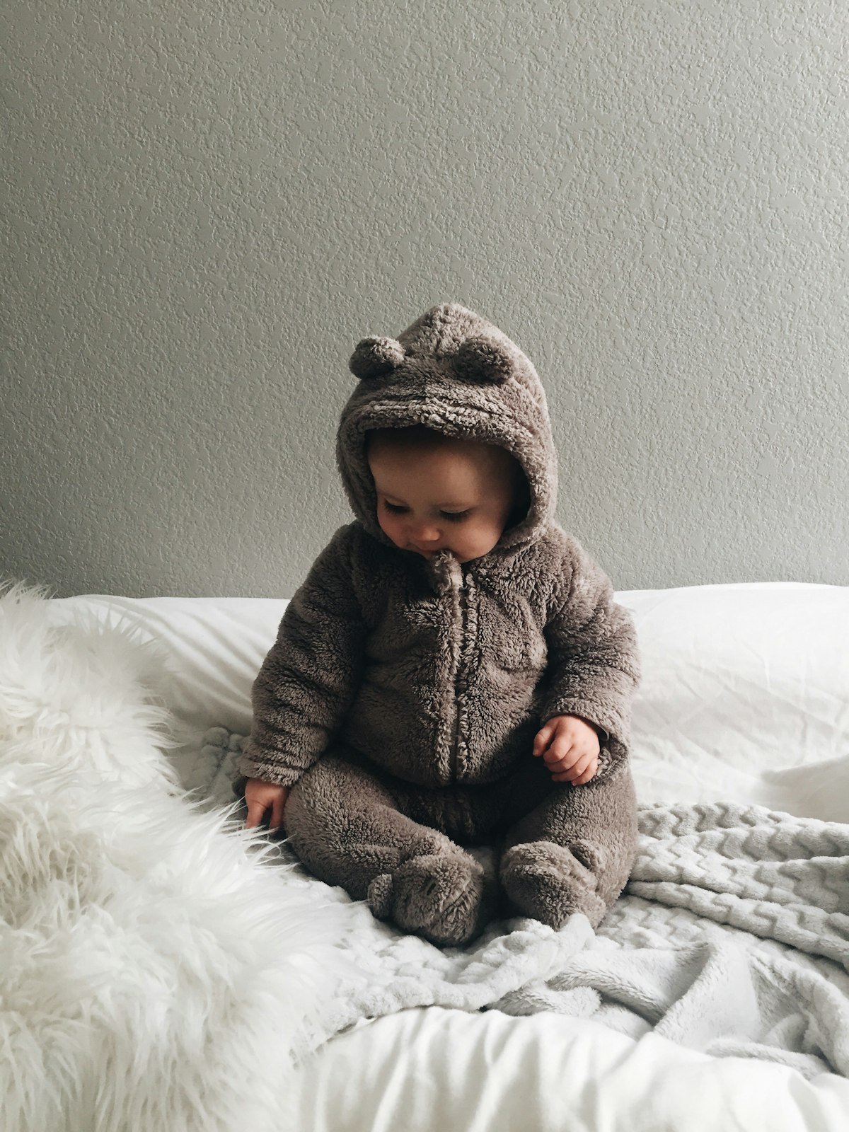 Baby in a cozy bear onesie during postpartum recovery days