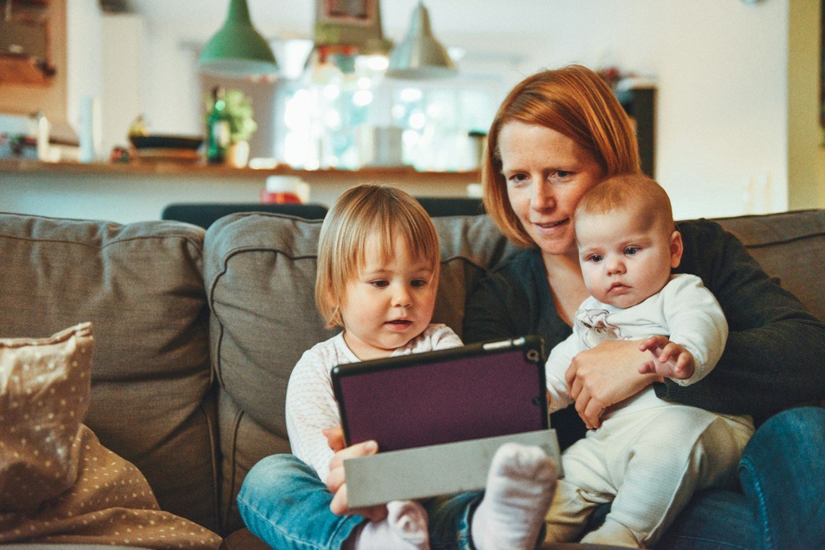 Mother spending a warm, quiet moment with her two children at home