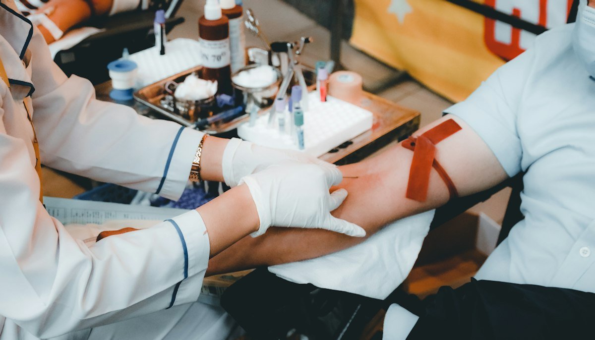 Provider drawing blood for lab work during an annual exam